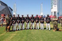 U.S. Marines with the United States Marine Corps Silent Drill Platoon pose for a photo with the military working dog handlers of Marine Corps Police Department Albany following their performance the College Football Aflac Kickoff show during Marine Week Atlanta in Atlanta, Ga., Aug. 31, 2025.The year 2025 marks the 250th anniversary of the United States Marine Corps, a milestone that highlights the legacy, transformation and enduring spirit of the Corps since 1775. Throughout the year, Marines across the globe will commemorate this anniversary by honoring the service and sacrifice of those who served before them and by remaining faithful to the motto Semper Fidelis. (U.S. Marine Corps photo by Cpl. Christopher Prelle)