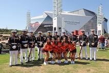 U.S. Marines with the United States Marine Corps Silent Drill Platoon pose for a photo with cheerleaders from Virginia Tech following their performance at the College Football Aflac Kickoff show during Marine Week Atlanta in Atlanta, Ga., Aug. 31, 2025. The year 2025 marks the 250th anniversary of the United States Marine Corps, a milestone that highlights the legacy, transformation and enduring spirit of the Corps since 1775. Throughout the year, Marines across the globe will commemorate this anniversary by honoring the service and sacrifice of those who served before them and by remaining faithful to the motto Semper Fidelis. (U.S. Marine Corps photo by Cpl. Christopher Prelle)