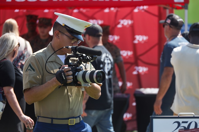 U.S. Marine Corps Lance Cpl. Elijua Guel, combat videographer, captures video footage during Marine Week Atlanta in Atlanta, Ga., Aug. 31, 2025. The year 2025 marks the 250th anniversary of the United States Marine Corps, a milestone that highlights the legacy, transformation and enduring spirit of the Corps since 1775. Throughout the year, Marines across the globe will commemorate this anniversary by honoring the service and sacrifice of those who served before them and by remaining faithful to the motto Semper Fidelis. (U.S. Marine Corps photo by Cpl. Christopher Prelle)