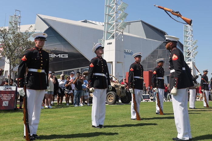 U.S. Marines with the United States Marine Corps Silent Drill Platoon execute their "rifle inspection" sequence during a performance at the College Football Aflac Kickoff show during Marine Week Atlanta in Atlanta, Ga., Aug. 31, 2025. The year 2025 marks the 250th anniversary of the United States Marine Corps, a milestone that highlights the legacy, transformation and enduring spirit of the Corps since 1775. Throughout the year, Marines across the globe will commemorate this anniversary by honoring the service and sacrifice of those who served before them and by remaining faithful to the motto Semper Fidelis. (U.S. Marine Corps photo by Cpl. Christopher Prelle)