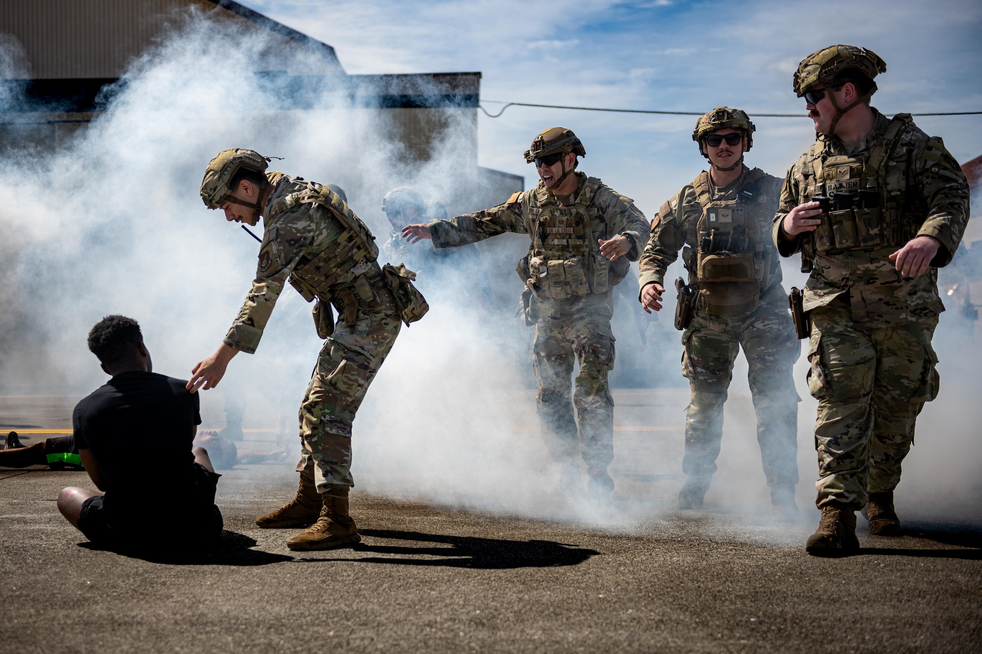 U.S. Air Force Airmen assigned to the 35th Security Forces Squadron begin to evacuate a crowd during an aircraft mass casualty exercise.