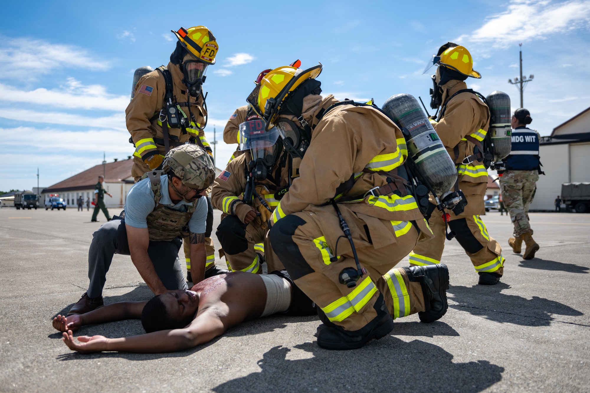 U.S. Air Force Airmen assigned to the 35th Civil Engineer Squadron fire protection and 35th Security Forces Squadron assess a simulated patient’s injuries during an aircraft mass casualty exercise.