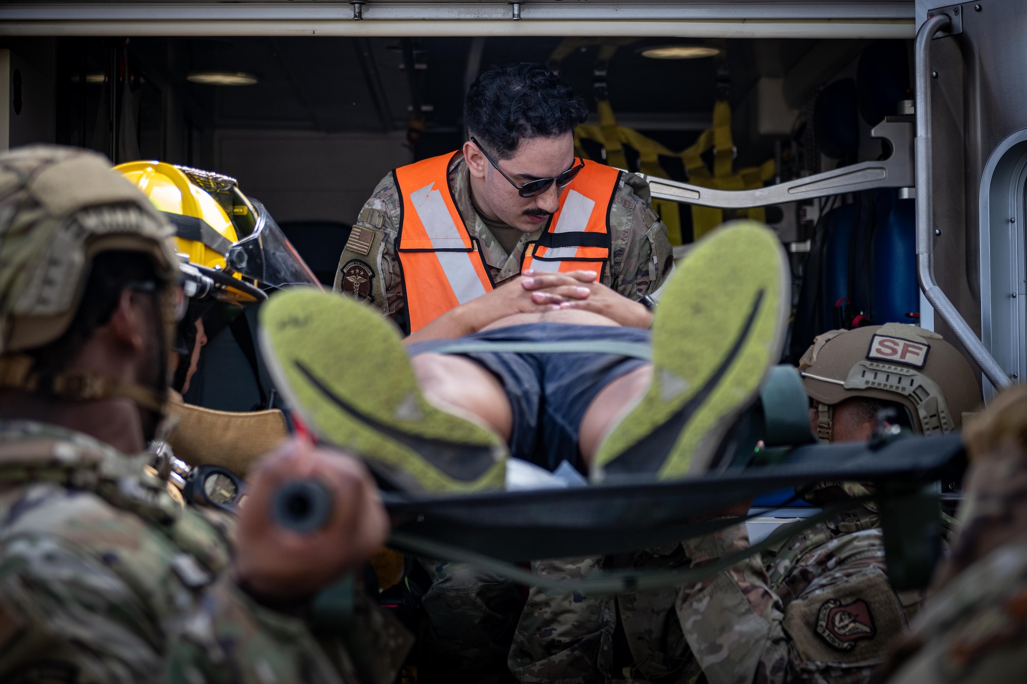 U.S. Air Force Airmen assigned to the 35th Fighter Wing lift a simulated patient into an ambulance during an aircraft mass casualty exercise.