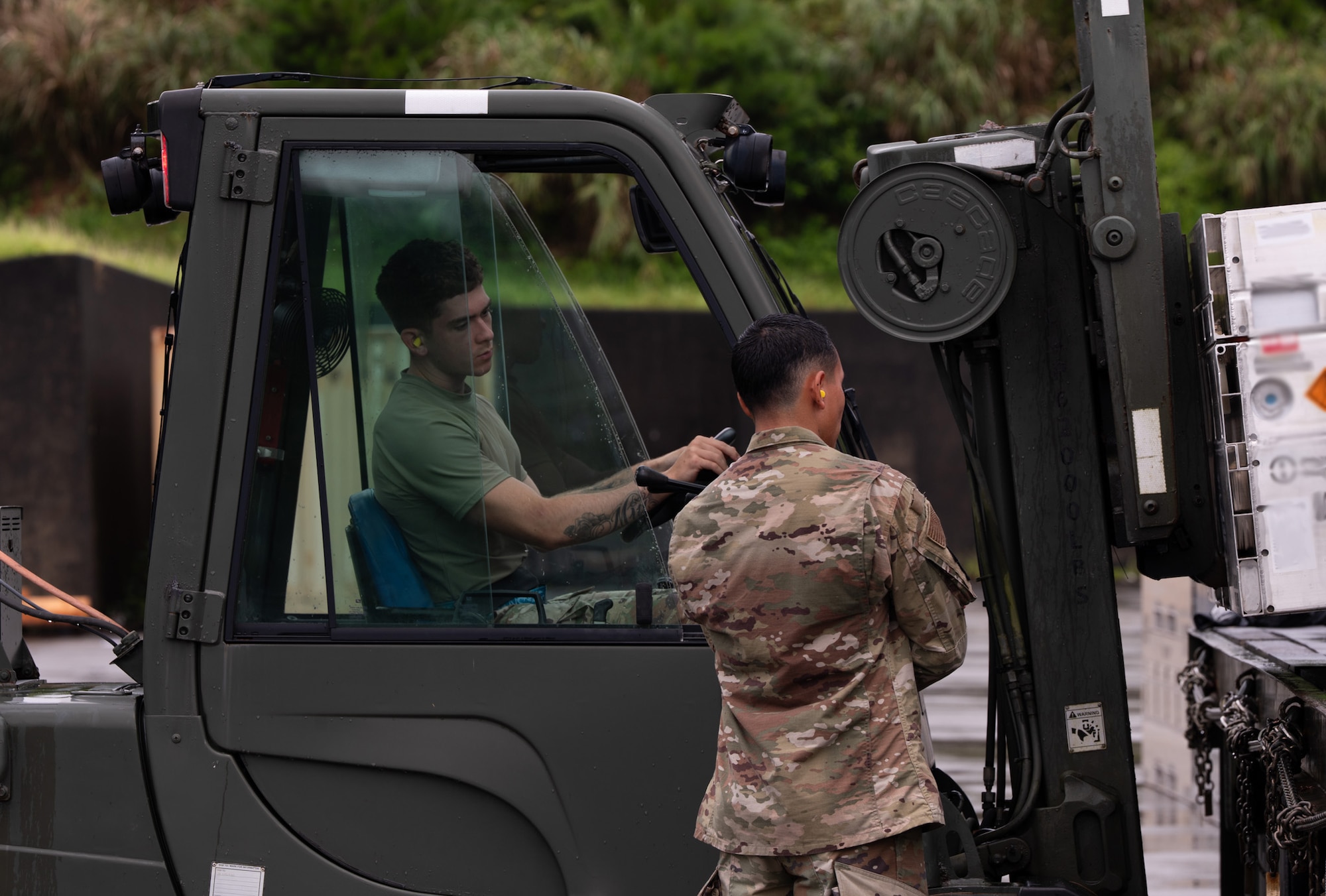 Airmen load cargo using a forklift.