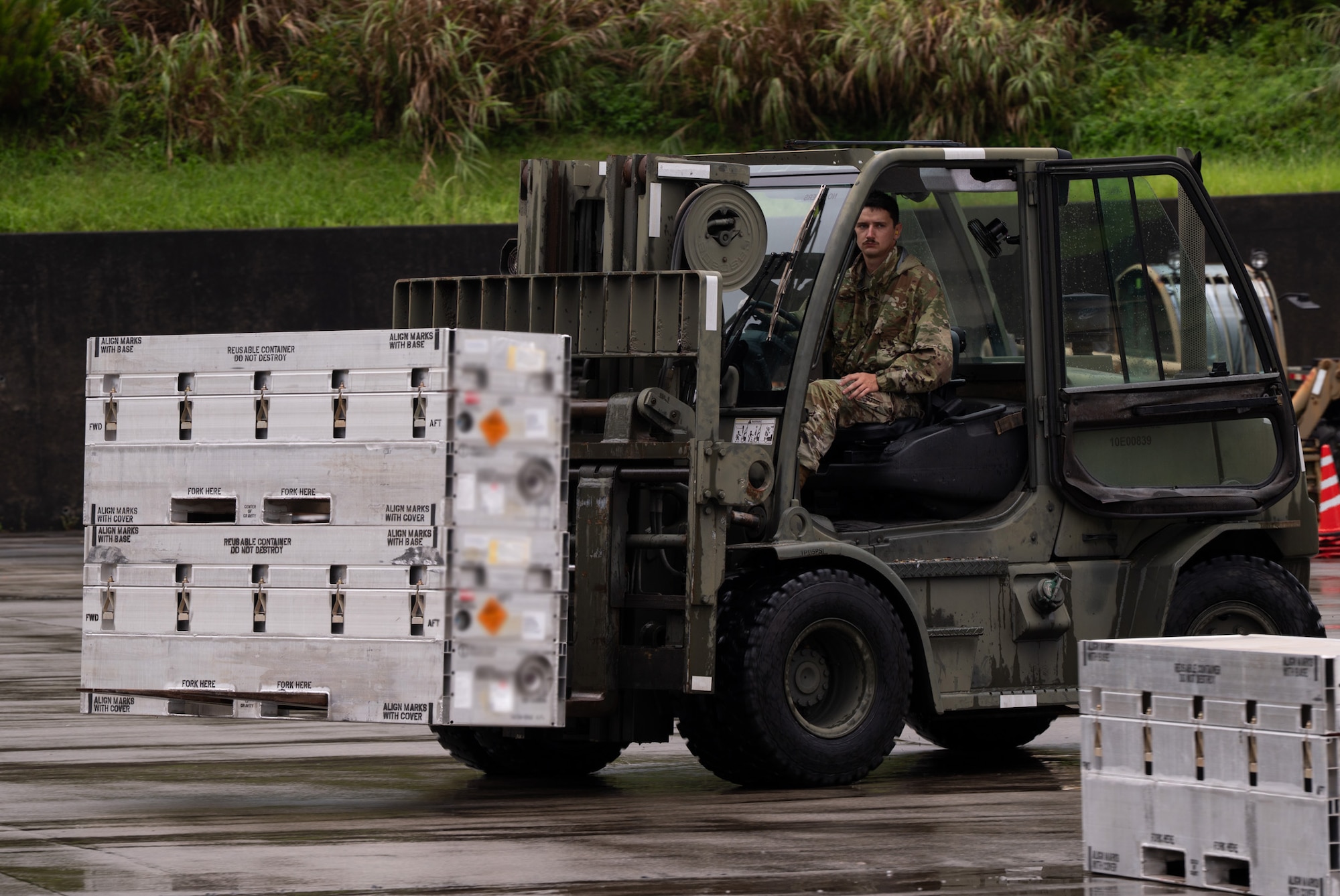 An airman loads cargo using a forklift.