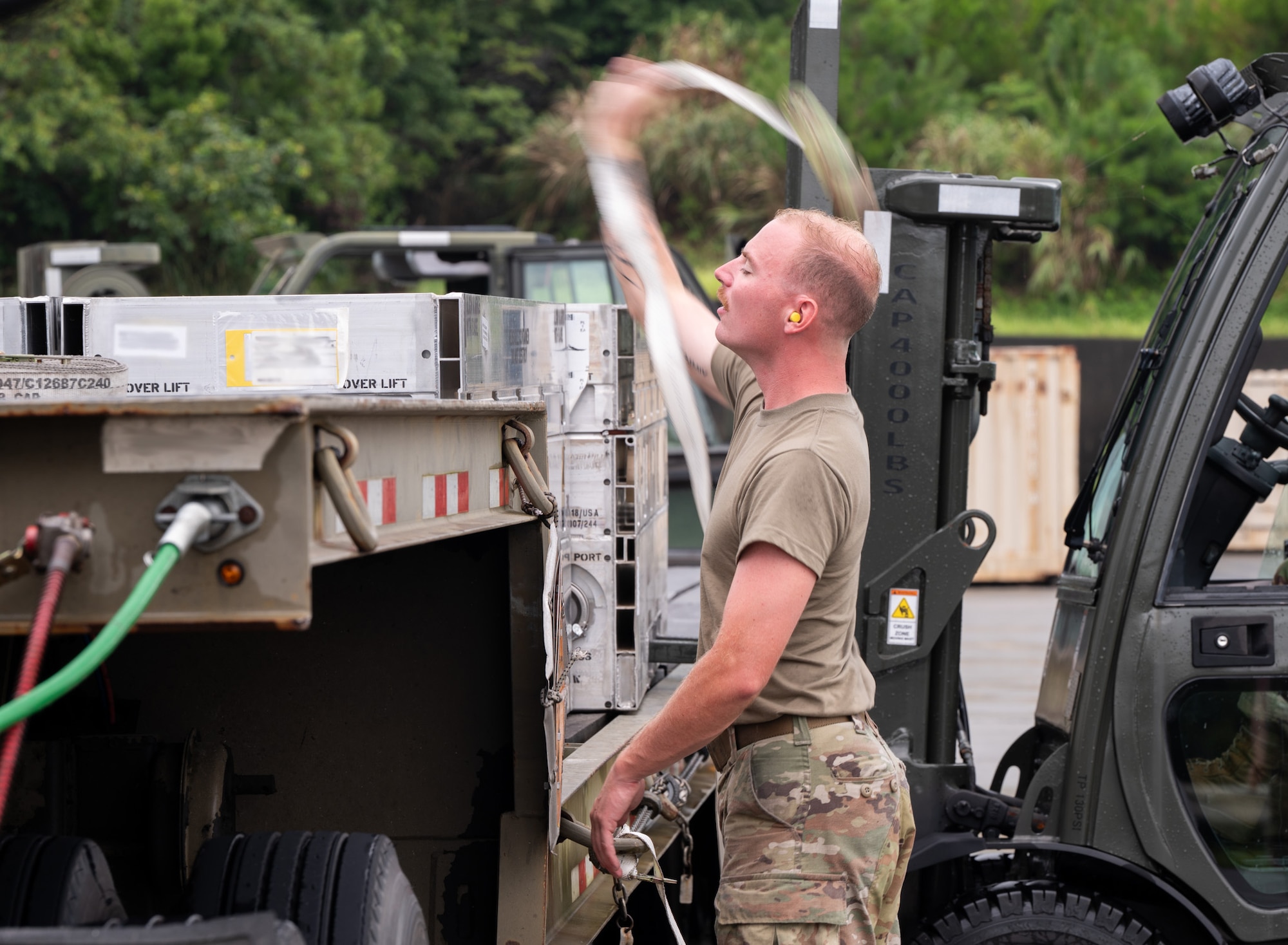 Airman straps down cargo.