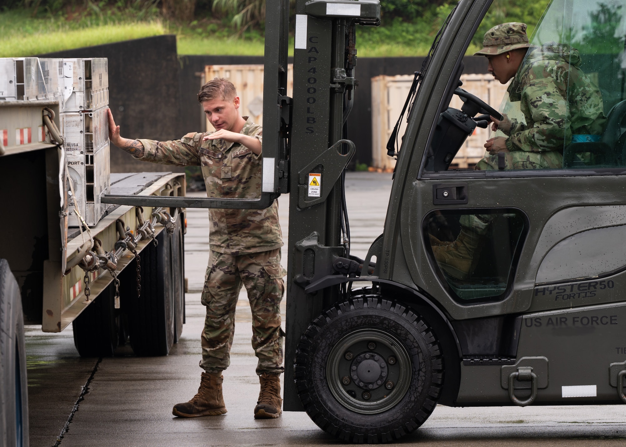 Service members unload cargo.
