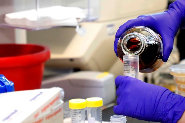 SILVER SPRING, Md. (Aug. 25, 2025) A researcher with Naval Medical Research Command transfers solution into a beaker in the Agile Vaccines and Therapeutics (AVAT) laboratory. Research is being conducted to test the effectiveness of new approaches to drug-resistant infections. NMRC, headquarters of Navy Medicine Research & Development, is engaged in a broad spectrum of activity from basic science in the laboratory to field studies in austere and remote areas of the world to investigations in operational environments. In support of Navy, Marine Corps and joint U.S. warfighter health, readiness and lethality, researchers study infectious diseases, biological warfare detection and defense, combat casualty care, environmental health concerns, aerospace and undersea medicine, operational mission support and epidemiology. (U.S. Navy photo by Aleece Williams/Released)