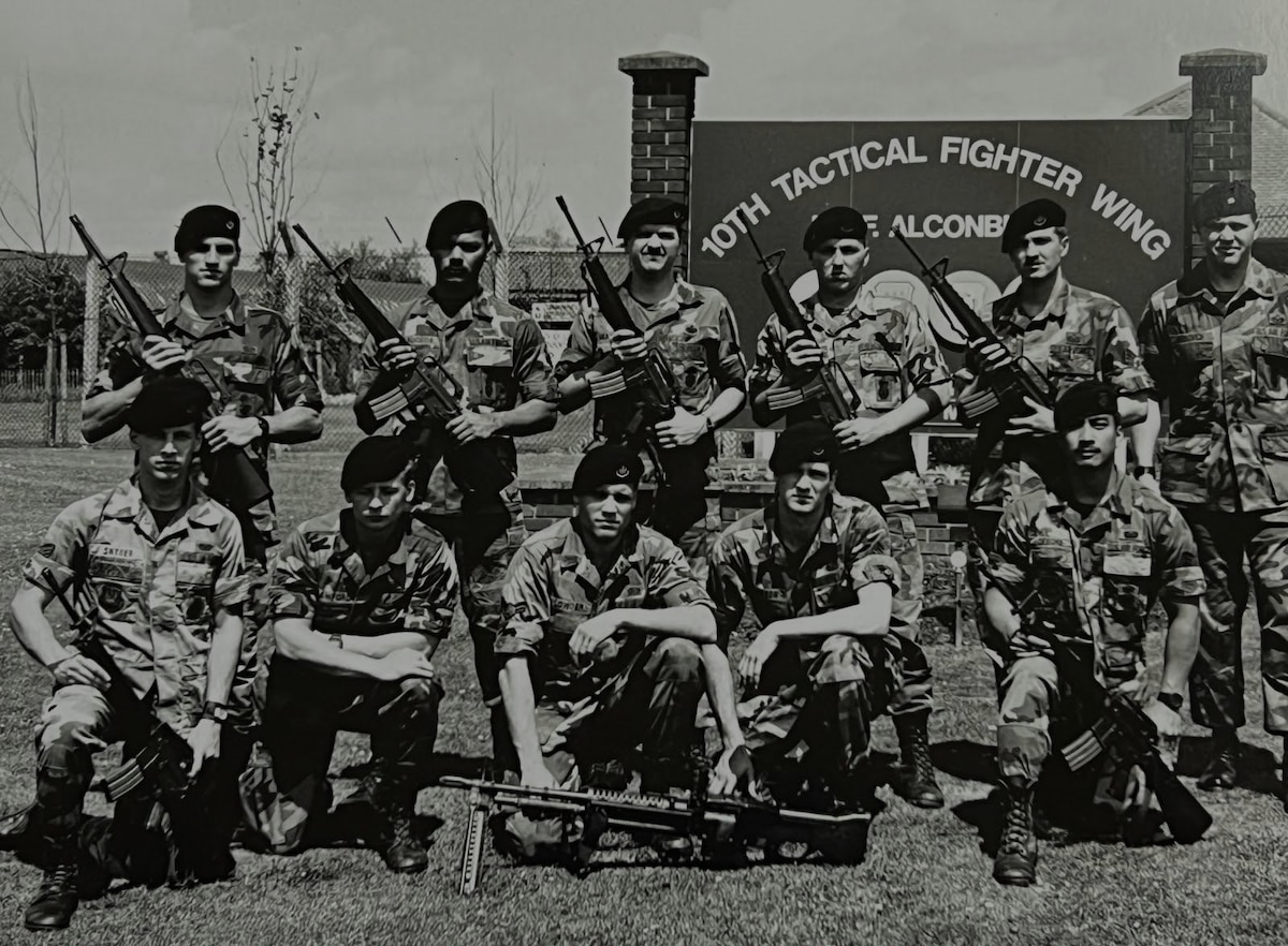 Lyndon Deboma (bottom right), chief of information protection for the 194th Wing, poses for a photo with the 1989 10th Security Police Squadron’s ‘Peacekeeper Challenge’ team on RAF Alconbury, U.K. Deboma’s team placed first in the tactics event known as the ‘Defender Challenge.’ (Courtesy photo)