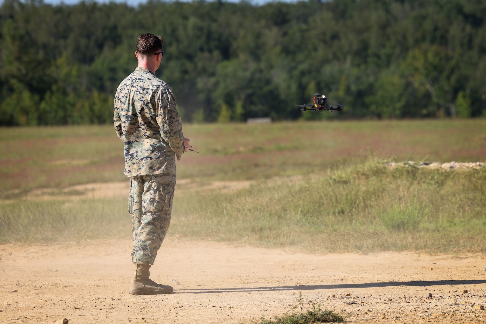 U.S. Marine Corps Cpl. Elijah Capra, a military police officer with the Security Battalion Counter Drone Team, flies an Unmanned Aerial Systems during an aerial target engagement simulation on Marine Corps Base Quantico, Virginia, August 27, 2025. This simulation is part of MCB Quantico’s Counter-Unmanned Aerial System’s Counter-Drone Team, which focuses on establishing standard operating procedures for the use of kinetic defeat options for law enforcement against a drone incursion. (U.S. Marine Corps photo by Lance Cpl. Jeffery Stevens)
