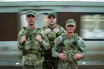 (From left) U.S. Army Sgt. Russell Dozier, Spc. Nichalos Garrison, and Staff Sgt. Zachery Graham all assigned to the 4-118th Infantry Regiment, South Carolina Army National Guard, stand together during a patrol of a Washington Metro station in Washington, D.C. Aug. 23, 2025.