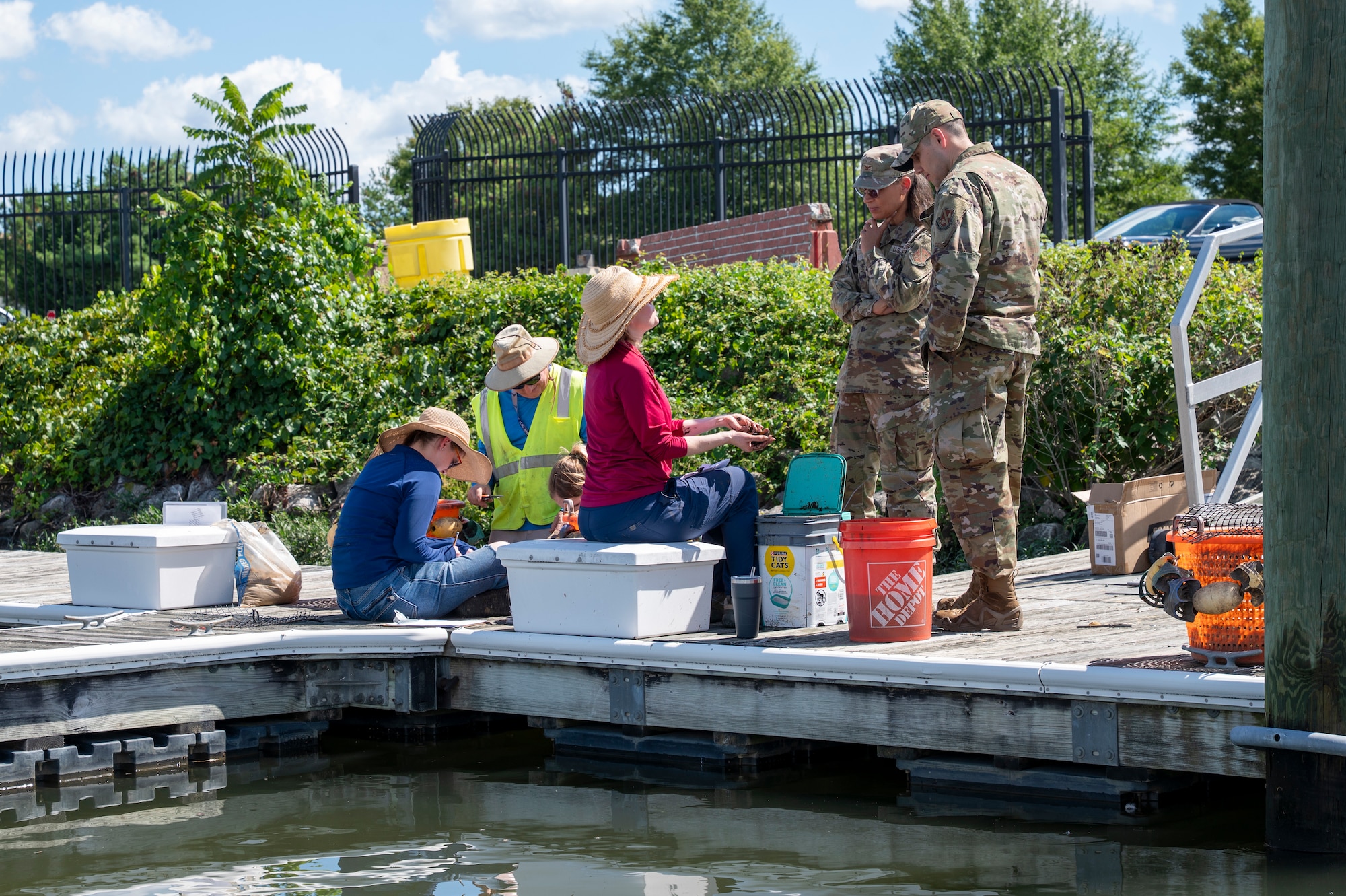 Jennifer McDonnell, center, installation management flight chief with the U.S. Air Force’s 11th Civil Engineer Squadron, speaks with U.S. Air Force Col. Angelique Nelson, center right, 11th Mission Support Group commander, and Lt. Col. Daniel R. Romero, right, 11th Civil Engineer Squadron commander, during the young mussel release event at Joint Base Anacostia-Bolling, Washington, D.C., Aug. 22, 2025. The 11th CES partnered with the National Fish and Wildlife Foundation and the Anacostia Watershed Society to release the mussels, which help clean the water by filtering excess nutrient pollutants. Located at the confluence of the Potomac and Anacostia Rivers, which empty into the Chesapeake Bay watershed, JBAB provides an ideal location for the release initiative. (U.S. Air Force photo by Hayden Hallman)
