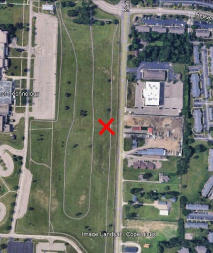 Aerial display of a map with buildings and a red "X"