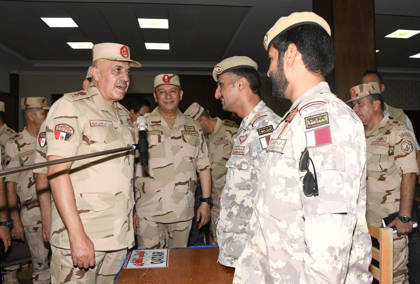 Lt. Gen. Ahmed Khalifa, Chief of Staff of the Egyptian Armed Forces, left, speaks with military personnel from friendly and partner nations participating in the BRIGHT STAR 25 Exercise at Mohamed Naguib Military Base, Aug. 26, 2025. BRIGHT STAR 25 enhances joint readiness and reinforces partner nations’ ability to integrate seamlessly in complex operational environments. By aligning tactics, techniques and procedures, U.S. and partner forces increase their capacity to deter aggression, improving lethality, confidence, and cohesion among multinational service members. (Courtesy photo Department of Morale Affairs, Egyptian Armed Forces – Caption writer, U.S. Central Command Maged Benjamin-Elias)