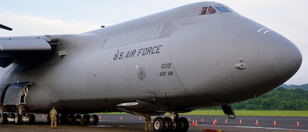 A C-5 Super Galaxy aircraft rests on the tarmac.