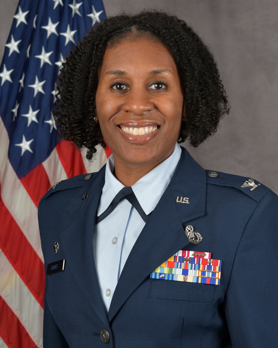 A woman poses for an official photo.