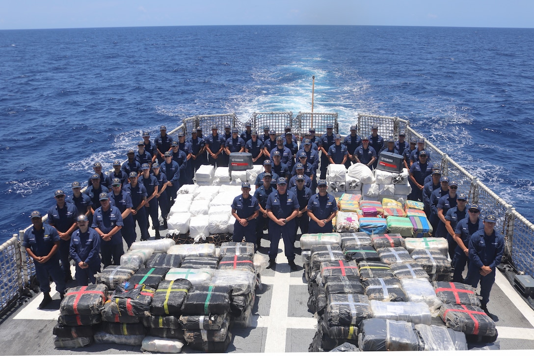 The crew of Coast Guard Cutter Vigilant (WMEC 617) poses for a photo with contraband seized or transferred aboard the cutter during a deployment in the Caribbean Sea, Aug. 16, 2025. Vigilant’s crew conducted a two-month, maritime border security patrol in the Windward Passage and Caribbean Sea to protect America’s maritime borders and prevent illicit drug smuggling in the region. (U.S. Coast Guard photo)