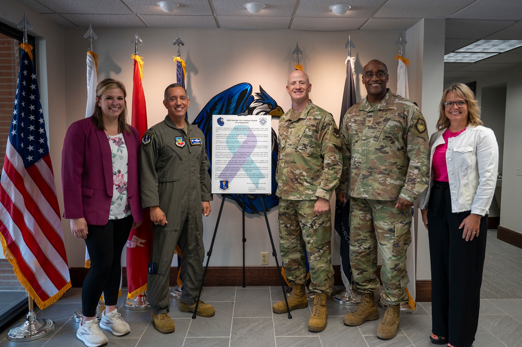The 319th Reconnaissance Wing Leadership Team stands with the 319th Integrated Resiliency Office after the signing of the 2025 Suicide Prevention Month Proclamation at Grand Forks Air Force Base, North Dakota, Aug. 25, 2025.