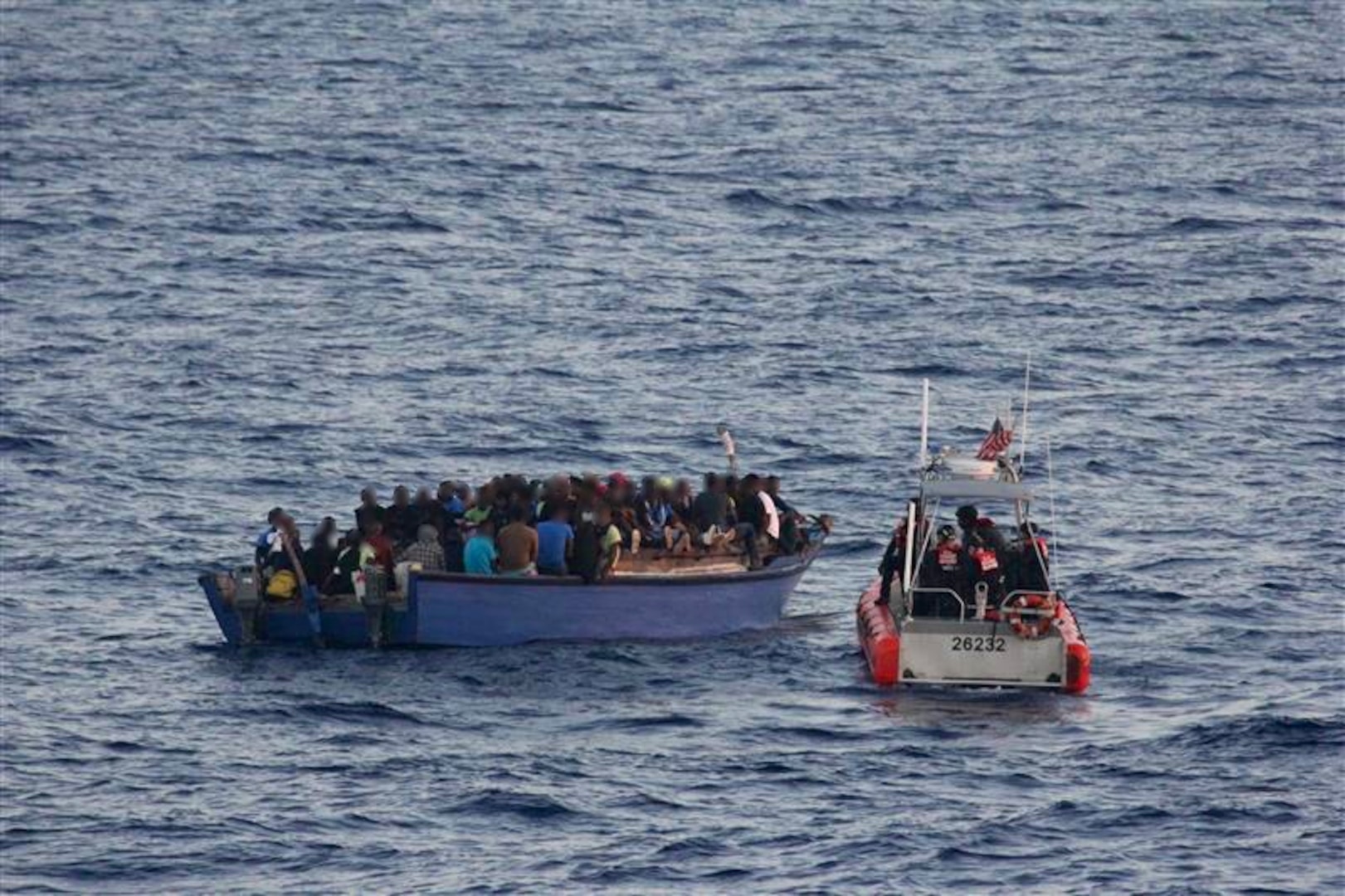 A law enforcement boat crew from USCGC Spencer (WMEC 905) intercepts an overloaded vessel with 191 Haitian aliens approximately 40 miles north of Cap Haitian, Haiti, Aug 29, 2025. All aliens aboard the vessel were repatriated back to Haiti, Sept 2, 2025 following the interdiction. (U.S. Coast Guard photo)