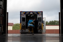 EMS personnel inspects the equipment on the ambulance