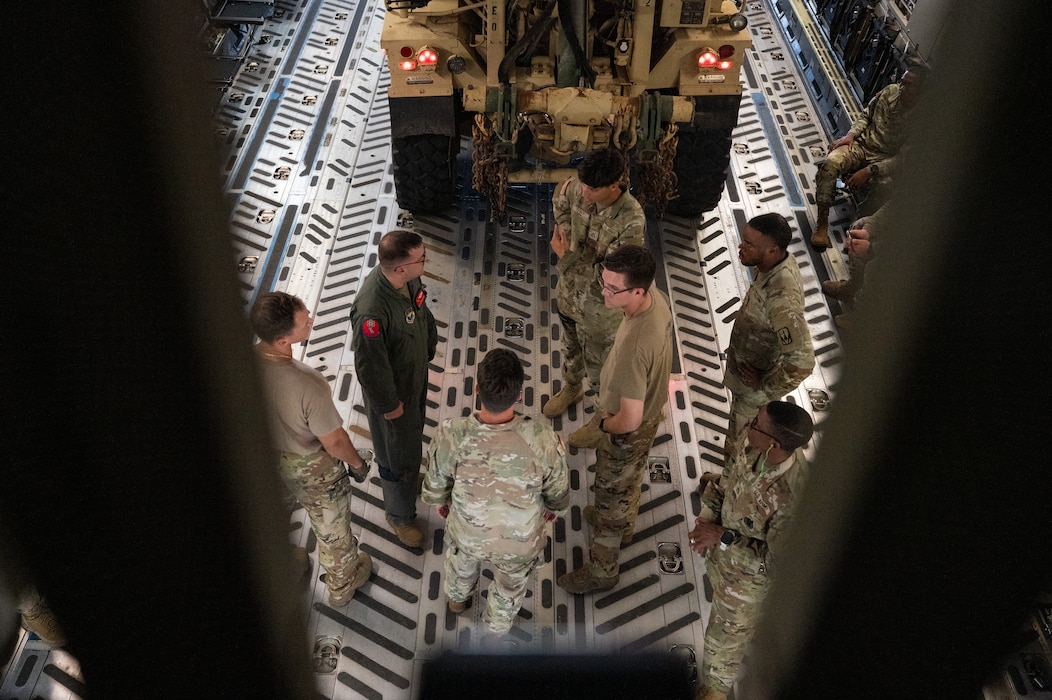 Loadmasters from the 58th Airlift Squadron brief U.S. Army Soldiers on the different configurations of how to load vehicles onto a C-17 Globemaster III aircraft during a training event at Altus Air Force Base, Okla., Aug. 20, 2025. The C-17 is capable of rapid strategic delivery of troops and all types of cargo to main operating bases or directly to forward bases in the deployment area. (U.S. Air Force photo by Tech. Sgt. Hailey Haux)