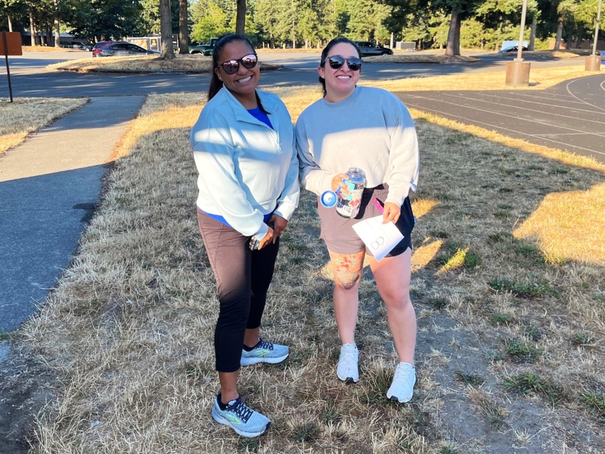 U.S. Air Force Senior Master Sgt. Vanessa Perkins, 627 Security Forces Squadron senior enlisted leader, left, and Senior Airman Jasmine Gonzalez, 627 SFS commander support staff, show their support before participating in the Run-A-Thon for the Dash for Danielle event at Joint Base Lewis-McChord, Washington, Aug. 8, 2025.