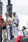 NAVAL BASE GUAM (August 31, 2025) Cmdr. Greg Storer, commanding officer, USS Springfield (SSN 761), left, and Lt. Cmdr. Juan Diaz, center, man the conning tower of the Los Angeles-class fast-attack submarine, August 31, 2025. Springfield returns to Guam after completing a routine deployment in the Indo-Pacific. Assigned to Commander, Submarine Squadron 15, based at Polaris Point, Naval Base Guam, Springfield is one of five forward-deployed fast-attack submarines. Renowned for their unparalleled speed, endurance, stealth, and mobility, fast-attack submarines are the backbone of the Navy’s submarine force. Regarded as apex predators of the sea, Guam’s fast-attack submarines serve at the tip of the spear, helping to reaffirm the submarine force's forward-deployed presence in support of a free and open Indo-Pacific. (U.S. Navy photo by Lt. James Caliva)
