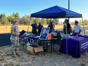 U.S. Air Force Chief Master Sgt. Kristy Korchak-Campbell, 62d Airlift Wing command chief, gives remarks during the Dash for Danielle event at Joint Base Lewis-McChord, Washington, Aug. 8, 2025.