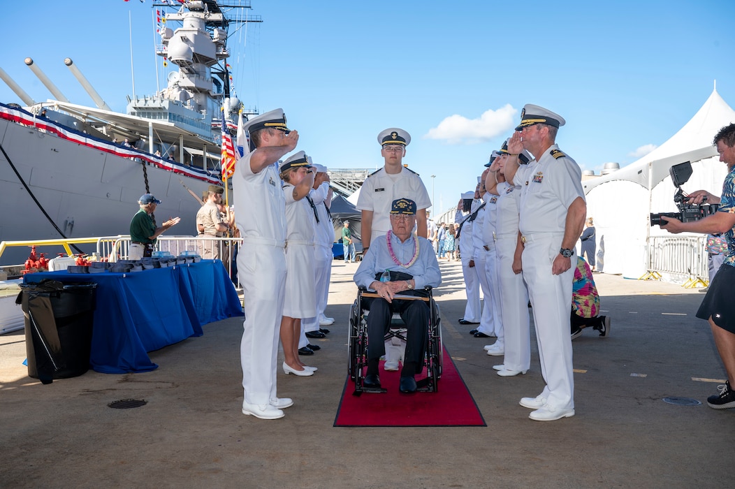 A World War II veteran is welcomed during a ceremony commemorating the 80th anniversary of the end of World War II in Pearl Harbor, Hawaii, Sept. 2, 2025.