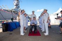 A World War II veteran is welcomed during a ceremony commemorating the 80th anniversary of the end of World War II in Pearl Harbor, Hawaii, Sept. 2, 2025.
