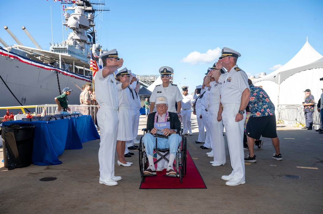 A World War II veteran is welcomed during a ceremony commemorating the 80th anniversary of the end of World War II in Pearl Harbor, Hawaii, Sept. 2, 2025.