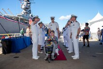 A World War II veteran is welcomed during a ceremony commemorating the 80th anniversary of the end of World War II in Pearl Harbor, Hawaii, Sept. 2, 2025.