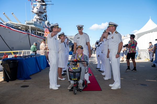 A World War II veteran is welcomed during a ceremony commemorating the 80th anniversary of the end of World War II in Pearl Harbor, Hawaii, Sept. 2, 2025.