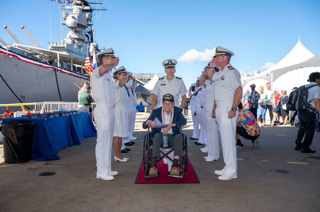 A World War II veteran is welcomed during a ceremony commemorating the 80th anniversary of the end of World War II in Pearl Harbor, Hawaii, Sept. 2, 2025.