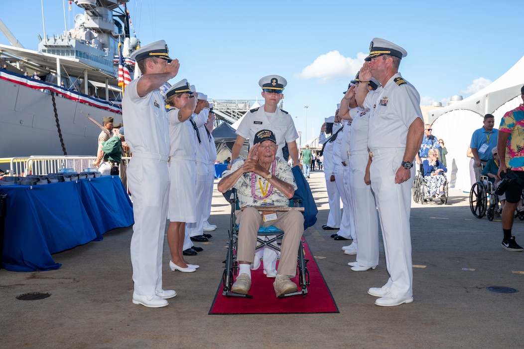 A World War II veteran is welcomed during a ceremony commemorating the 80th anniversary of the end of World War II in Pearl Harbor, Hawaii, Sept. 2, 2025.