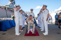A World War II veteran is welcomed during a ceremony commemorating the 80th anniversary of the end of World War II in Pearl Harbor, Hawaii, Sept. 2, 2025.