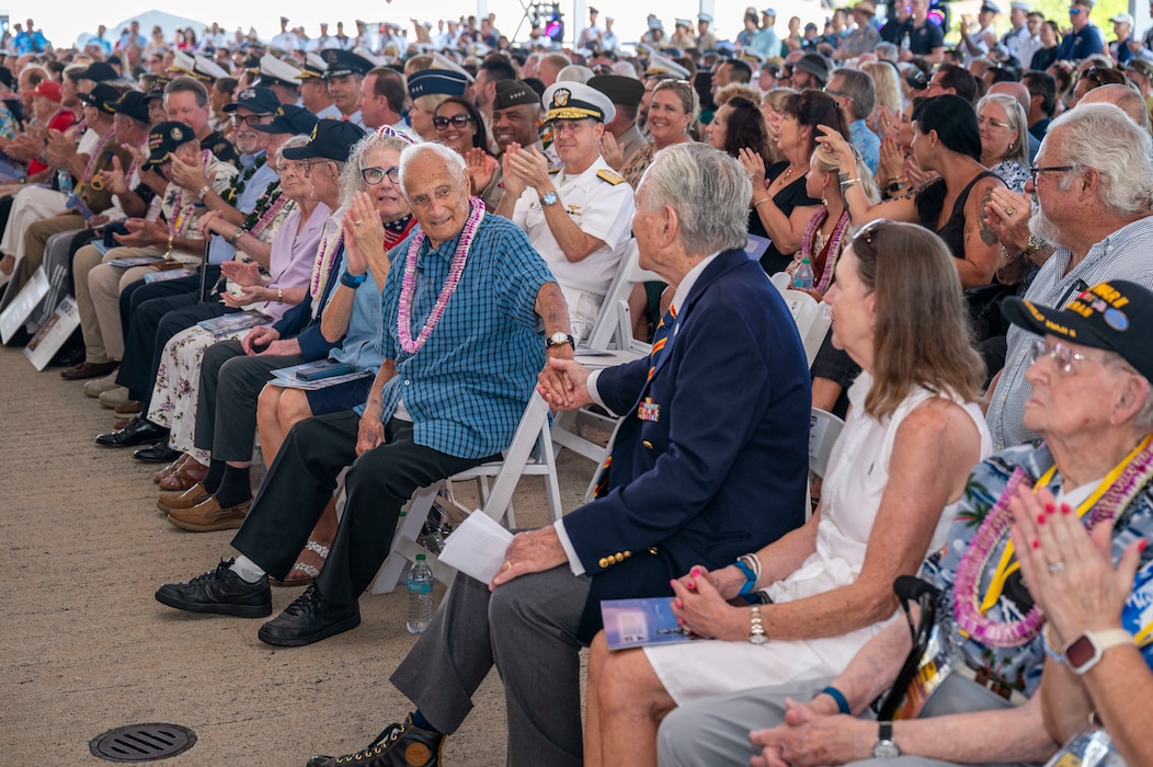World War II Navy veterans John DeLeo, center left, and Edgar Buffman, center right, embrace each other during a ceremony commemorating the 80th anniversary of the end of World War II in Pearl Harbor, Hawaii, Sept. 2, 2025.