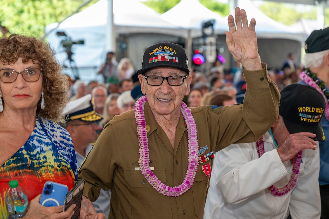 A World War II veteran is applauded during a ceremony commemorating the 80th anniversary of the end of World War II in Pearl Harbor, Hawaii, Sept. 2, 2025.