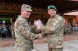 U.S. Army South Commander Maj. Gen. Philip Ryan presents Chilean General de Brigada Claudio Mardones Petermann, commander of the 3rd Mountain Division, with a gift during the closing ceremony for Exercise Southern Vanguard 25 in Los Ángeles, Chile, Aug. 29, 2025. Exercise Southern Vanguard 25 underscores the U.S. Army’s enduring commitment to regional partnership as U.S. forces deploy to Chile to conduct combined mountain warfare, field, and command post training alongside Chilean forces, with participation from Argentina and Peru - strengthening interoperability, shared readiness, and mutual trust while advancing regional security and cooperation across the Western Hemisphere. (U.S. Army National Guard photo by Sgt. 1st Class Sebastian Rothwyn)
