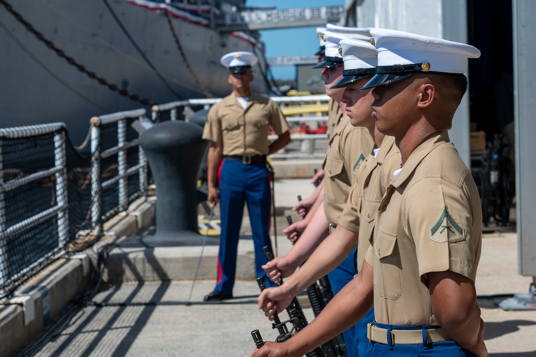 Marines assigned to 3rd Radio Battalion stand at parade rest prior to conducting a rifle salute during a ceremony commemorating the 80th anniversary of the end of World War II in Pearl Harbor, Hawaii, Sept. 2, 2025.