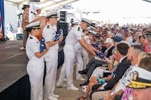 Members of the Hawaii Army and Navy Reserve Officers' Training Corps present flags to World War II veterans during a ceremony commemorating the 80th anniversary of the end of World War II in Pearl Harbor, Hawaii, Sept. 2, 2025.