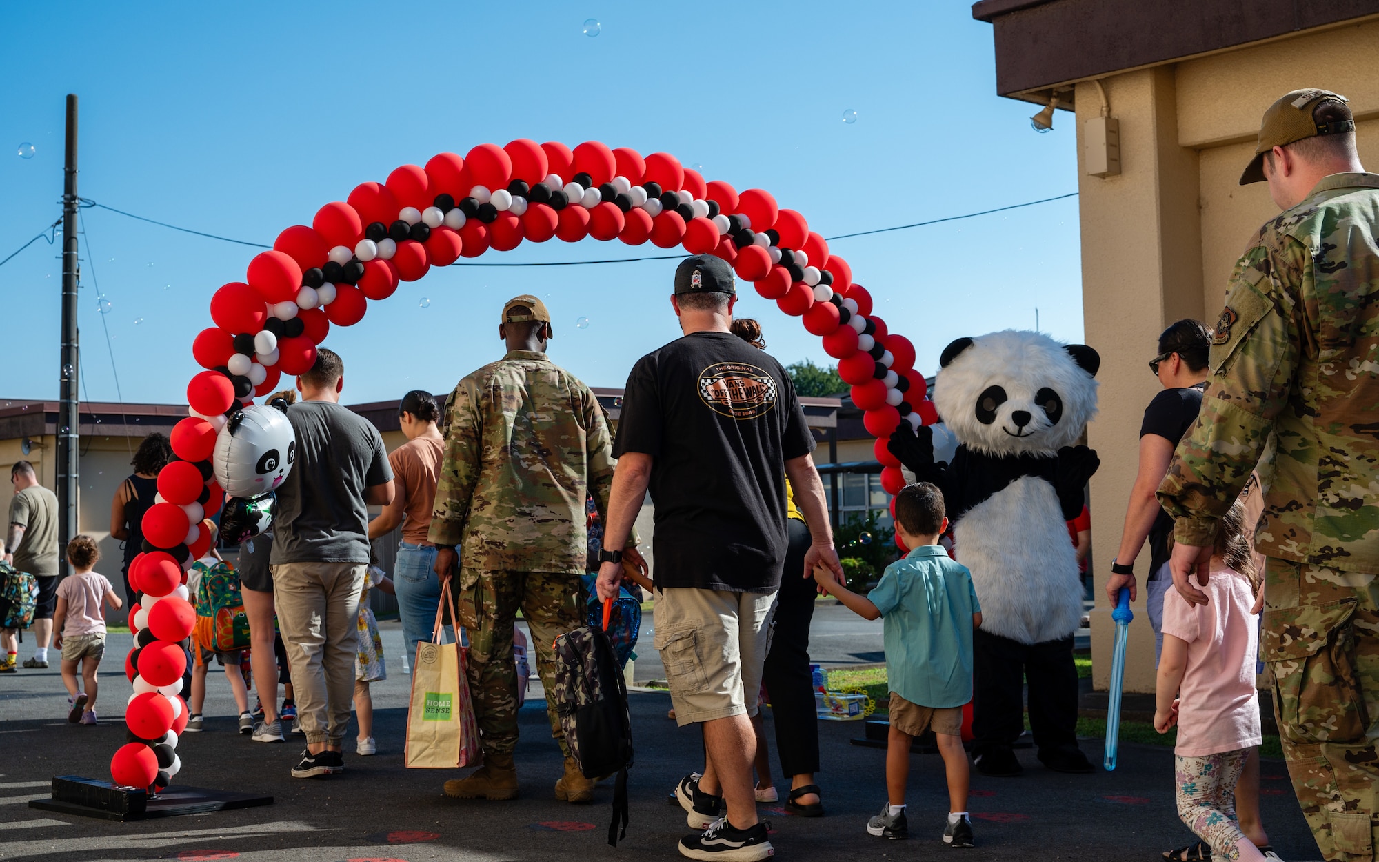 Students walk with their parents as they begin their first day of universal pre-kindergarten at Joan K. Mendel Elementary School on Yokota Air Base, Japan.