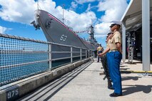 Marines assigned to 3rd Radio Battalion stand at parade rest prior to conducting a rifle salute during a ceremony commemorating the 80th anniversary of the end of World War II in Pearl Harbor, Hawaii, Sept. 2, 2025.
