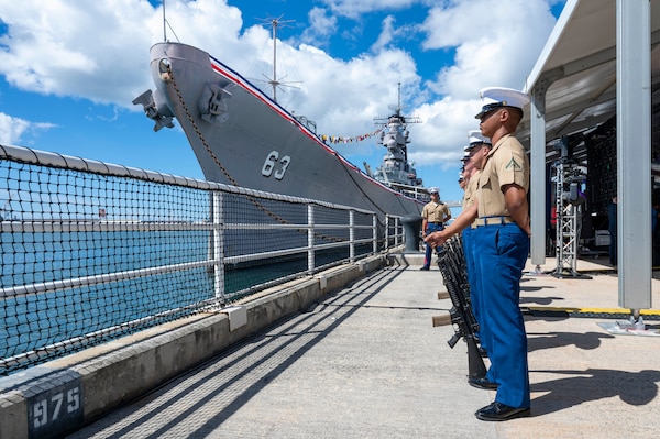 Marines assigned to 3rd Radio Battalion stand at parade rest prior to conducting a rifle salute during a ceremony commemorating the 80th anniversary of the end of World War II in Pearl Harbor, Hawaii, Sept. 2, 2025.