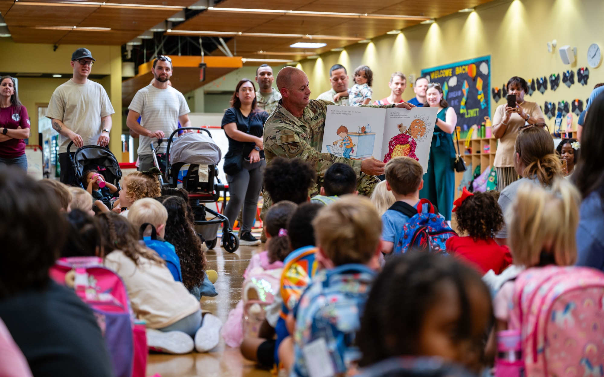 U.S. Air Force Col. Richard McElhaney, 374th Airlift Wing commander, reads to students on their first day of universal pre-kindergarten at Joan K. Mendel Elementary School on Yokota Air Base, Japan.