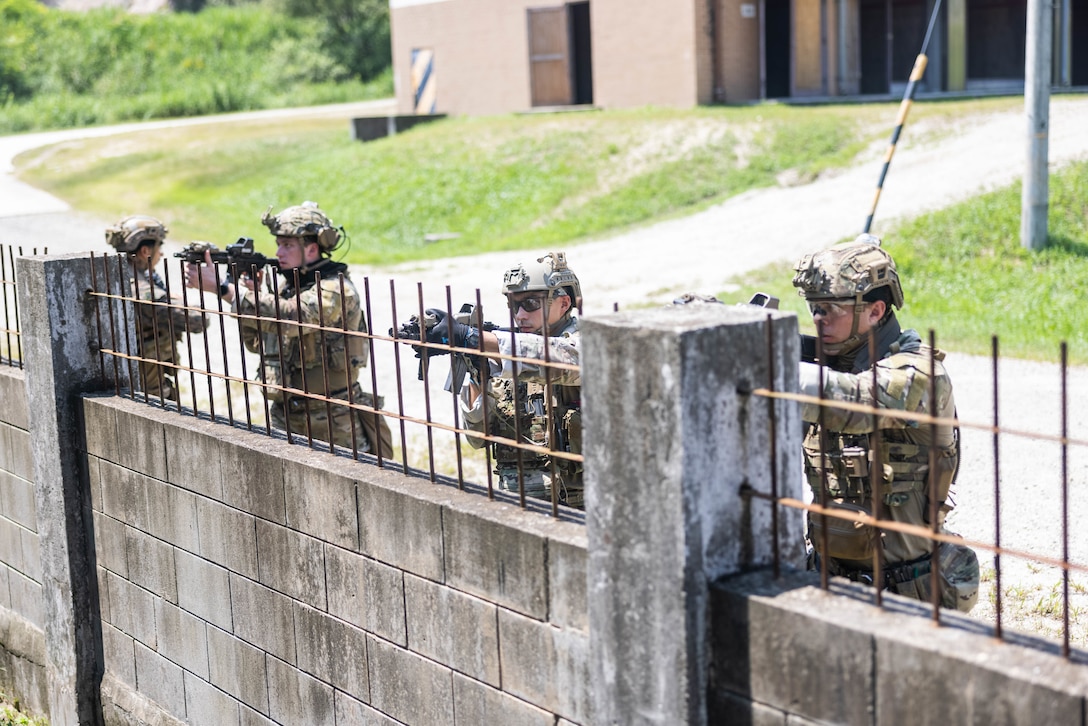 U.S. Marines with Explosive Ordnance Disposal Company, 9th Engineer Support Battalion, 3rd Marine Logistics Group, and Navy Sailors with EOD Mobile Unit One, EOD Group One, forward-deployed with Commander, Task Group 75.1, prepare to enter an uncleared building during naval integrated small team close quarters battle tactics training at the Combined Arms Collective Training Facility during Korean Marine Exchange Program 25.2 on Rodriguez Live Fire Complex, South Korea, July 29, 2025. KMEP is a semiannual bilateral exercise that brings together ROK and U.S. Marine Corps units to enhance combined capabilities and combat readiness, strengthen the ROK-U.S. alliance, and reinforce regional stability and deterrence on the Korean Peninsula and across the Indo-Pacific. (U.S. Marine Corps photo by Sgt. Paley Fenner)