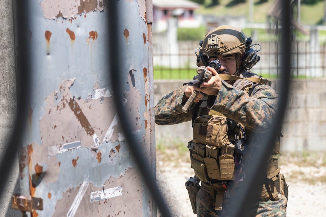 U.S. Marine Corps Sgt. Fred Aquilina, an explosive ordnance disposal technician with EOD Company, 9th Engineer Support Battalion, 3rd Marine Logistics Group, holds security outside an uncleared building during naval integrated small team close quarters battle tactics training at the Combined Arms Collective Training Facility during Korean Marine Exchange Program 25.2 on Rodriguez Live Fire Complex, South Korea, July 29, 2025. KMEP is a semiannual bilateral exercise that brings together ROK and U.S. Marine Corps units to enhance combined capabilities and combat readiness, strengthen the ROK-U.S. alliance, and reinforce regional stability and deterrence on the Korean Peninsula and across the Indo-Pacific. Aquilina is a native of California. (U.S. Marine Corps photo by Sgt. Paley Fenner)
