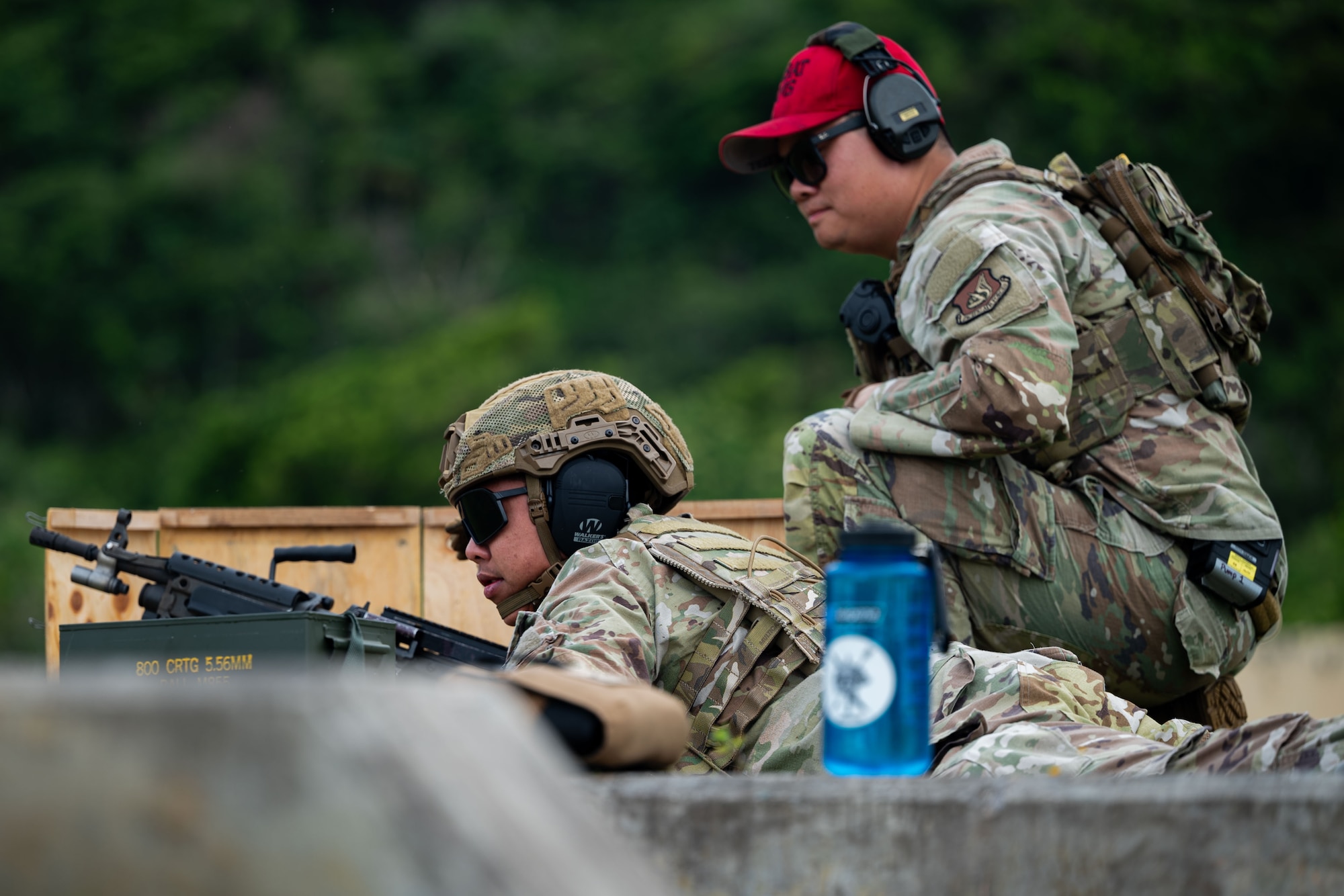 Photo of an Airman preparing to fire an M249 Squad Automatic Weapon