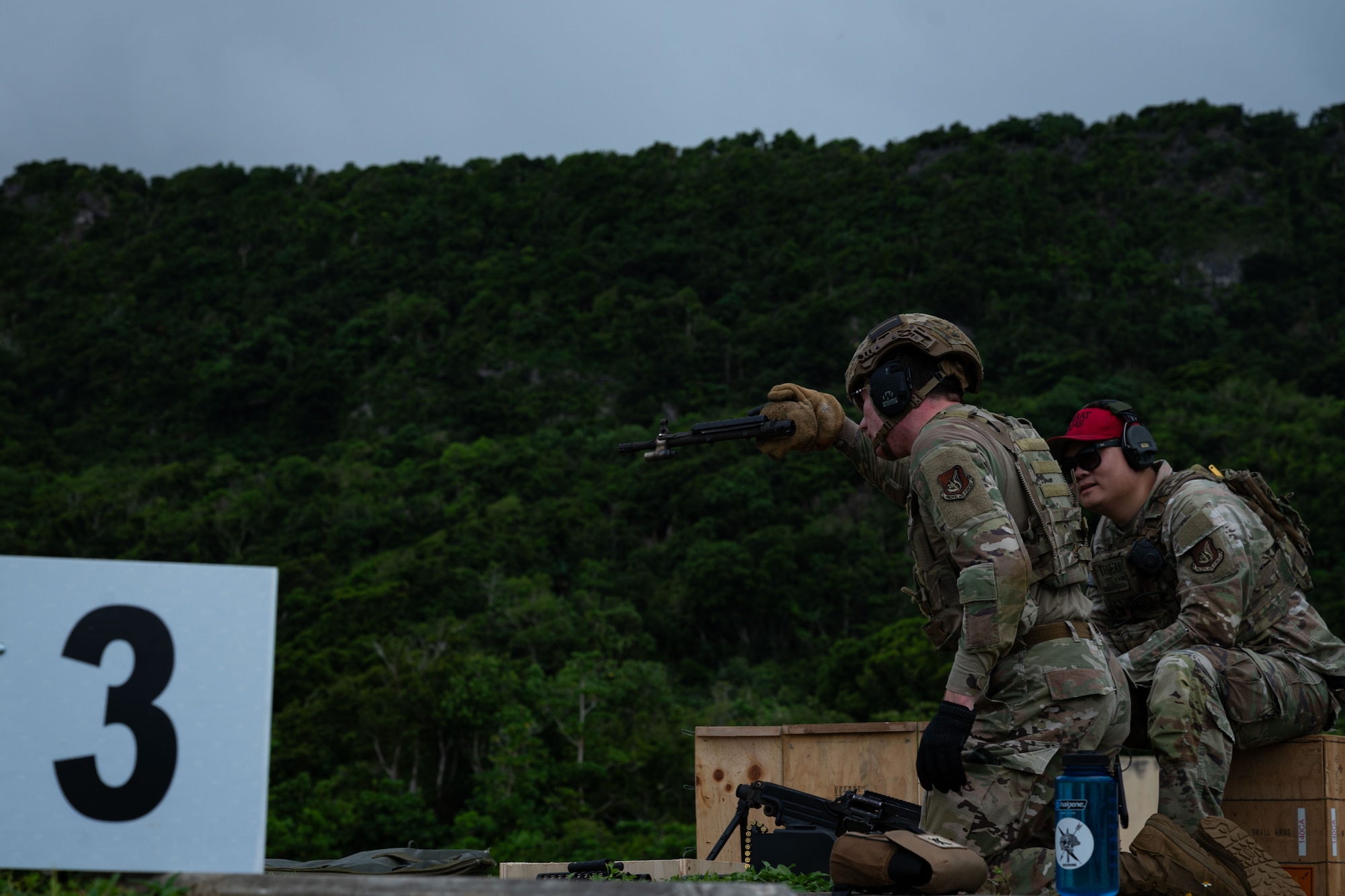 Photo of an Airman inspecting an M249 barrel