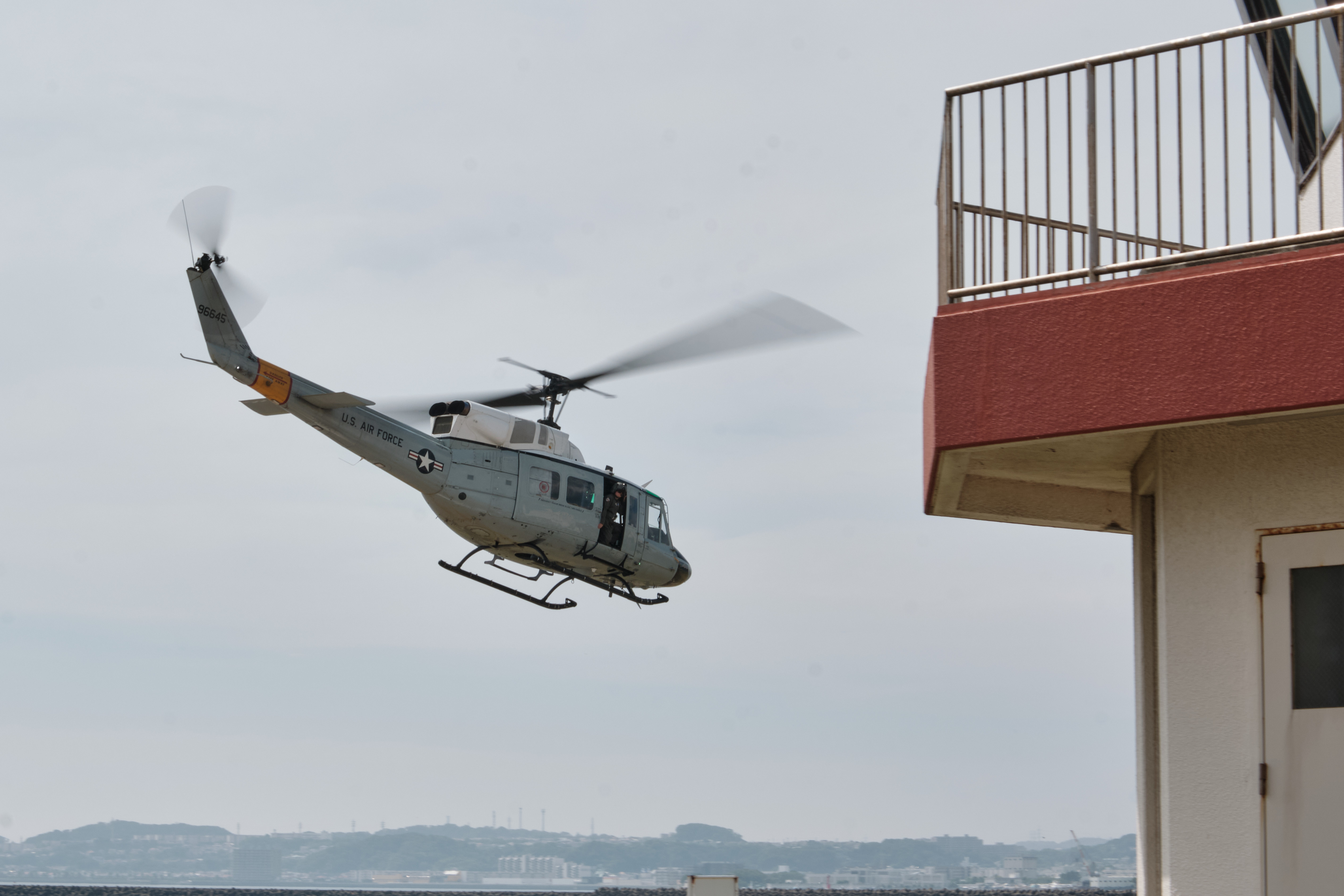 A U.S. Air Force UH-1N Twin Huey from Yokota Air Base departs Commander, Fleet Activities Yokosuka, Japan's Chess Romeo August 7, 2025. Chess Romeo is the installation's helopad for flight operations.